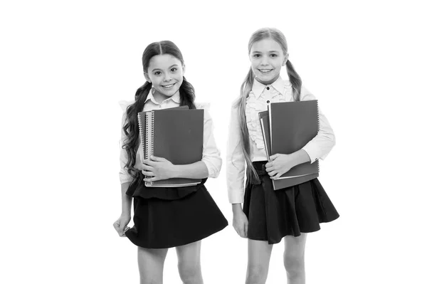 We are writing our future. Small girls holding copybooks for writing lesson. Little children learn reading and writing at school. Learning writing skills in primary school — Stock Photo, Image