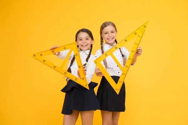 Pupil school girls big rulers. School knowledge. Explore world with math. Mathematical theory combining algebraic and geometric methods. Discover mathematics patterns. School students study geometry — Stock Photo, Image