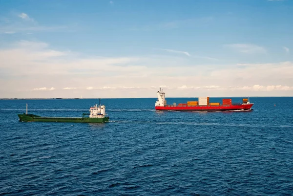 Barges ship cargo containers in sea in Copenhagen, Denmark. Cargo ships float in blue sea on idyllic sky. Marine transport and transportation. Shipping and shipment. Logistics — Stock Photo, Image