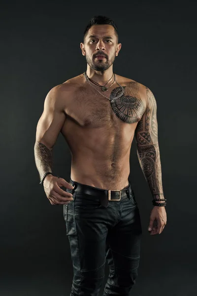 Tattoo culture concept. Tattoo brutal attribute. Man brutal unshaven hispanic appearance tattooed arms. Bearded man show tattooed torso. Brutal strict macho with tattoos. Masculinity and brutality — Stock Photo, Image