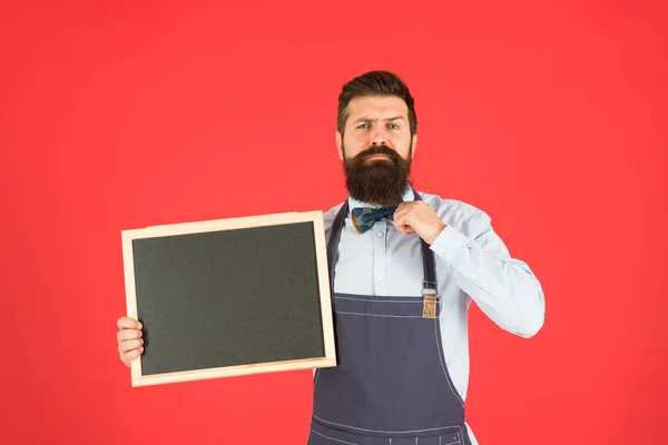 Happy hours. Store sale. Black friday discount. Advertising concept. Cafe shop advertising. Man bearded hipster in apron. Chef with blackboard copy space. Advertising place. Guy showing information