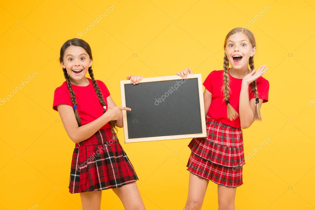 Just look at this. place for announcement. information office. school project presentation. copy space. children presenting bulletin board. big sales. happy small girls with blackboard.