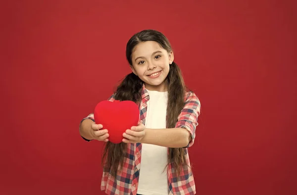 Having healthy heart. Little child expressing love on valentines day. Little girl holding big red heart. Cute girl in love. Happy valentines day. Shes a heart health expert