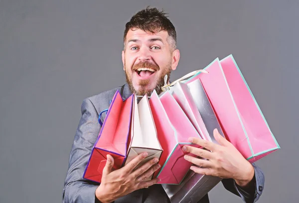 Exclusive commercial offer. Man bearded businessman customer carry many shopping bags. Enjoy shopping profitable deals black friday. Shopping with discount enjoy purchase. Satisfying shopping tour