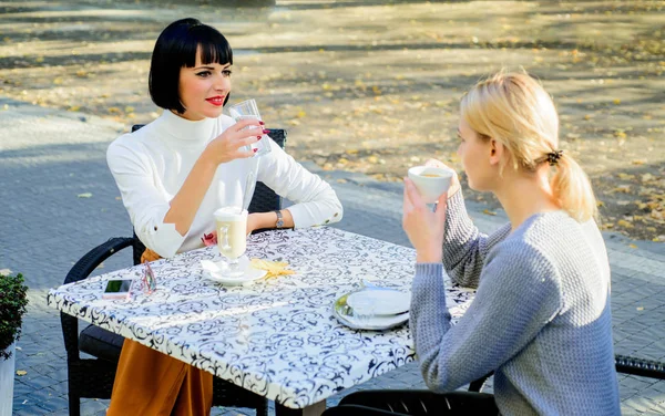 Girls friends drink coffee and talk. True friendship friendly close relations. Conversation of two women cafe terrace. Friendship meeting. Sharing thoughts. Female friendship. Trustful communication