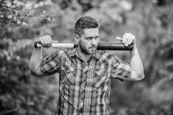 Wild energy. Power and strength. Feel my strength. Man unshaven strict face hold black baseball bat. Strong temper. Principle concept. Confident in his strength. Bully guy in nature with cudgel — Stock Photo, Image