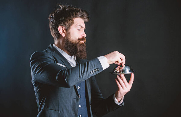 Best chef ever. Mature hipster with beard hold food tray in restaurant. brutal caucasian hipster hold metallic dish. businessman in suit. Waiter man. Perfect recipe. Bearded man chef presenting meal