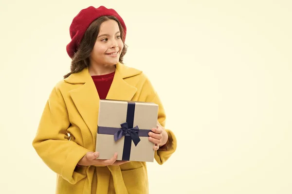 Spring shopping concept. Buy clothes and cute little gifts for spring season. Satisfying shopping day. My wish list. Child stylish hold gift box. Girl cute little lady coat and beret carry gift