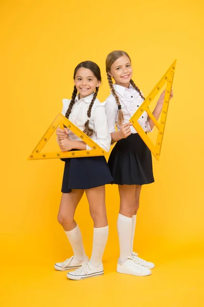 School knowledge. Explore world with math. Discover mathematics patterns. Mathematical theory combining algebraic and geometric methods. School students study geometry. Pupil school girls big rulers — Stock Photo, Image