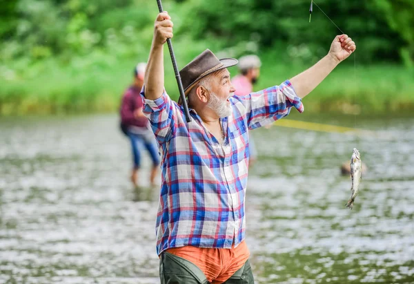 Dare al tuo hobby un nuovo Wing pothunter. uomo cattura il pesce. attività sportiva e hobby. Esche di trota. Pescatore barbuto in pensione. pesca d'altura. uomo maturo pesca. weekend estivo. pescatore con canna da pesca — Foto Stock