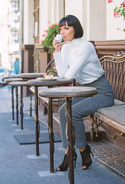 Utsökt och gourmetsnack. Girl Relax café med kaffe och dessert. Kvinna attraktiv elegant brunett njuta dessert och kaffe Café terrass bakgrund. Dessert koncept. Trevlig tid och avkoppling — Stockfoto