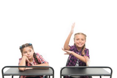 Onların bilgisi üzerinde çok çalışıyorlar. Okul masalarında bilgi testi geçen sevimli küçük okul çocukları. Bilgi ve beceri. Bilgi günü veya 1 Eylül