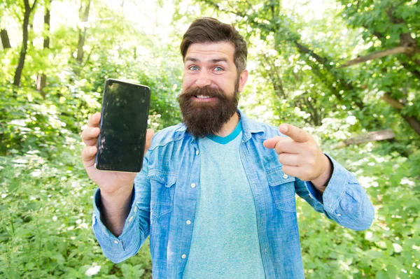 Man bearded wanderer walking in forest with navigation application. Hiking with navigation app. Route for exciting adventure. GPS and navigation apps. Useful program. Smartphone online navigation