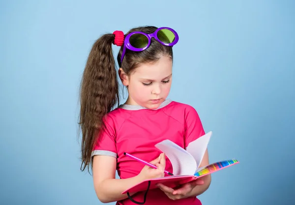 Playa lee para el verano. Al niño le gusta leer libros. Libros populares de vacaciones. Concepto de literatura. Grandes libros para las vacaciones de verano. Una chica con gafas de sol sostiene el libro. Hobby y ocio. Top libros divertidos para leer —  Fotos de Stock