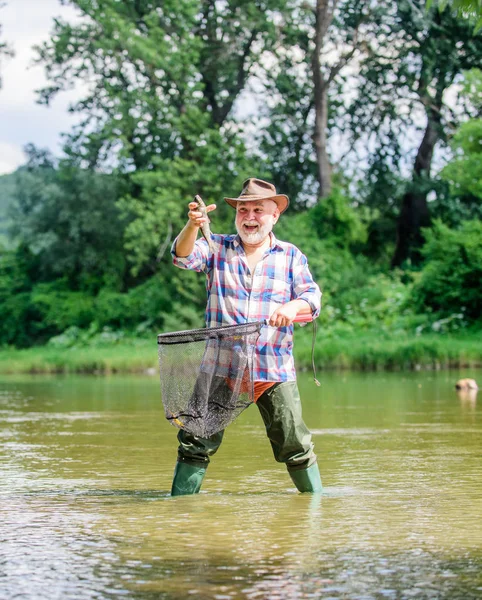 Retirement Is Just The Beginning. pothunter. man catching fish. mature man fishing. retired bearded fisher. big game fishing. weekend. fisherman with fishing rod. sport activity and hobby. Trout bait