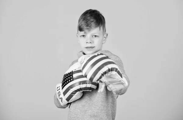 punching knockout. Childhood activity. workout of small boy boxer. Sport success. Confident in his fitness regime. energy health. usa independence day. Happy child sportsman in boxing gloves