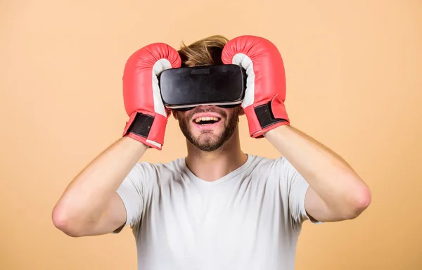 Cyber sport concept. Cyber coach online training. Cyber sportsman boxing gloves. Augmented 3D world. Man boxer virtual reality headset simulation. Man play game in VR glasses. Explore cyber space
