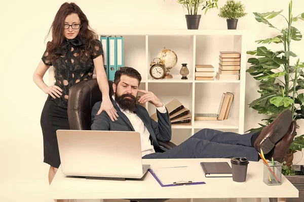 Business people and office staff. Sexy secretary personal assistant. Typical office life. Man bearded hipster boss sit in leather armchair office interior. Boss and secretary girl at workplace