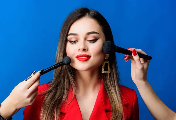 Attractive woman applying makeup brush. Perfect skin tone. Stunning beauty. Looking good and feeling confident. Professional makeup supplies shop. Makeup courses. Gorgeous lady make up red lips