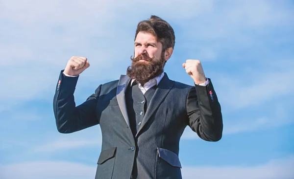 Success and luck. Man bearded optimistic businessman wear formal suit sky background. Optimistic mood. Think like optimist. Being optimistic. Celebrate success. Hopeful and confident about future