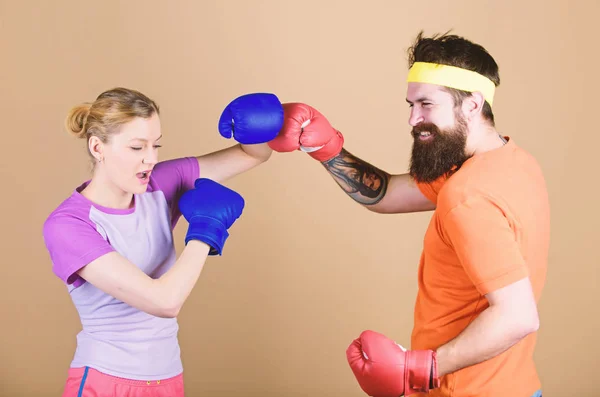 Punching, sport Success. sportswear. Fight. knockout and energy. couple training in boxing gloves. Happy woman and bearded man workout in gym. training with coach. Make your competitive juices — Stock Photo, Image