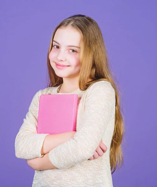 Girl hold book violet background. Kid show book. Book concept. Wise quotes. Childhood literature. Development and education. Reading skill. Personal diary. Textbook presentation. Study and learn — Stock Photo, Image
