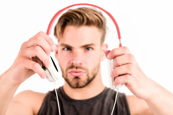 Professional software and devices. Entertainment concept. Man handsome guy hold headphones. Music taste. Check out music album. Music as daily therapy. Audio training for motivation. Listen music