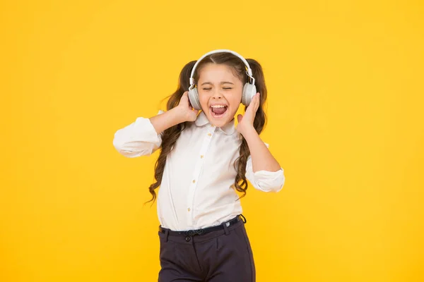 Child enjoy music sound. Audio schooling. Home schooling. Small girl pupil headphones. Child happy listen music. Audio book. Education and fun concept. Online schooling. Listening lesson. Sing song — Stock Photo, Image