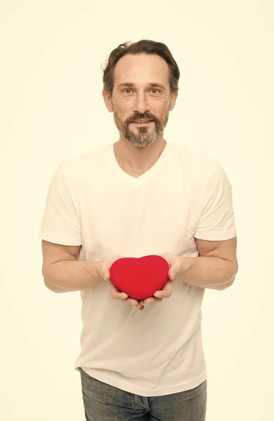 Love is in the air. Mature bearded man with red heart. Love. problems with heart. Man with beard. Decorative for valentines day. heart transplant. Holiday celebration. Valentines day. Health care