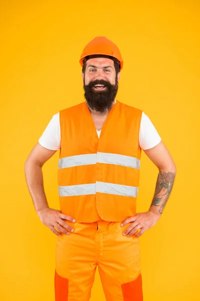 Engineering career concept. Architect builder engineer. Labor day. Safety apparel for construction industry. Bearded brutal hipster safety engineer. Man engineer protective uniform orange background — Stock Photo, Image