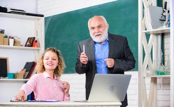 Caring teacher. modern school education. student and tutor with laptop. happy student girl with tutor man at blackboard. senior teacher and woman at school lesson. pass exam. teachers room — Stock Photo, Image