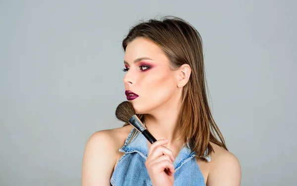 fashion makeup visage. beauty hairdresser salon. Lipstick and eyeshadow. sexuality. skincare cosmetics. sexy woman with professional make up brush. sensual woman with long hair. Hair loss and care