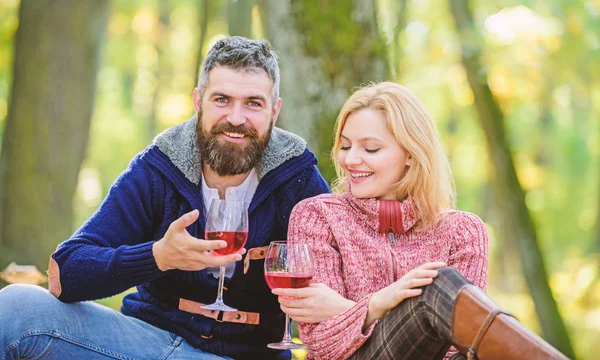 一緒に公園でリラックス幸せな愛するカップル。森の中でワインとロマンチックなピクニック。愛のカップルは記念日のピクニックデートを祝います。完璧なデートを楽しんでカップルはワインを抱きしめる — ストック写真