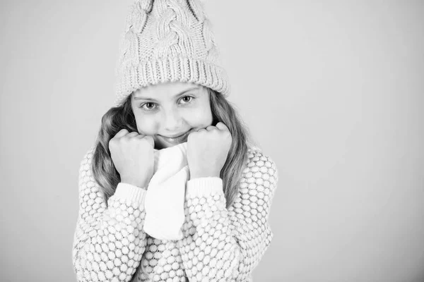 Moda de invierno concepto de ropa de abrigo. Accesorios cálidos que te mantendrán acogedor invierno. Niño pelo largo sombrero de lana caliente disfrutar de calor y suavidad. Niña desgaste de punto cálido sombrero relajante fondo rosa — Foto de Stock