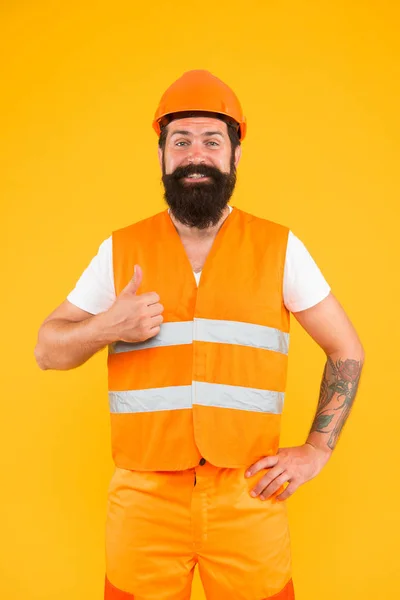 Good job. Safety apparel for construction industry. Bearded brutal hipster safety engineer. Man engineer protective uniform orange background. Engineering career concept. Architect builder engineer — Stock Photo, Image