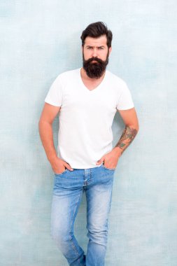 Gündelik tarzı günlük yaşam. Basit ve sıradan. Erkeklik kavramı. Erkek öfke vahşeti. Acımasız maço rahat kıyafet gri arka plan. Moda ve güzellik. Hipster uzun bakımlı sakal ve bıyık