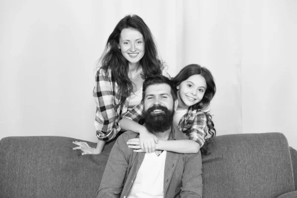 Hugs Are Fully Returnable. Bearded man and woman love daughter. Father, mother and child at home. Family day. Little girl love her parents at home. Childrens day. Happy family. Love and trust