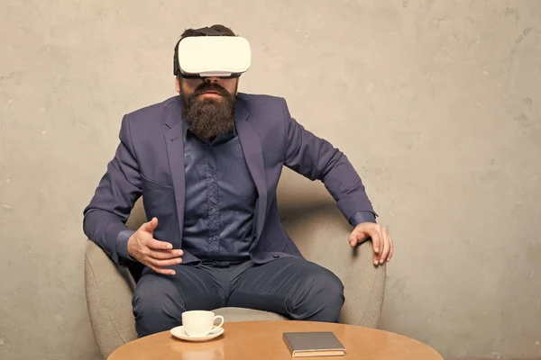 Businessman sit chair wear hmd explore virtual reality or ar. New opportunity. Modern software for business. Business implement modern technology. Business partner interact in virtual reality