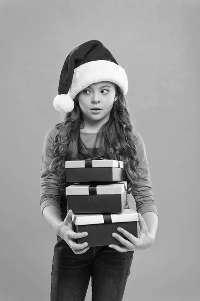 Happy winter holidays. Small serious girl. Little girl child in santa hat. New year party. Santa claus kid. Present for Xmas. Childhood. Christmas shopping. Black friday. big sale