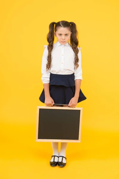 Sad news. Schoolgirl offended pupil informing you. School girl hold blank chalkboard copy space. Announcement and promotion. Girl school uniform hold blackboard. Back to school. Something happened — Stock Photo, Image