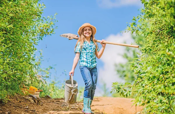 Summer farming. farmer little girl. garden, shovel and watering can. kid worker sunny outdoor. family bonding. spring country side village. future success. little girl on rancho. My job is my passion — Stock Photo, Image