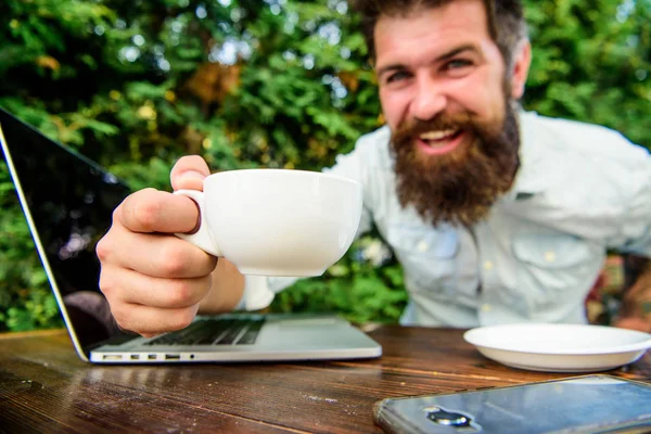 Freelance professional occupation. Online blog. Caffeine booster for productivity. Blogger freelance editor. Workaholic stereotype. Drink coffee work faster. Bearded man freelance worker. Remote job