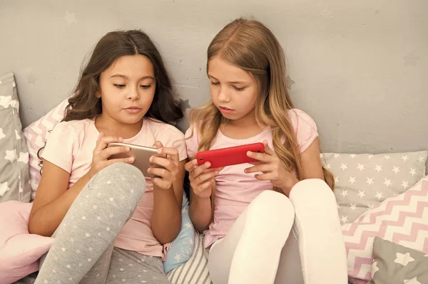 Smartphone application concept. Girlish leisure pajama party. Girls smartphone little bloggers. Online entertainment. Explore social network. Smartphone for entertainment. Kids taking selfie