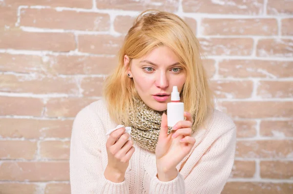 Runny nose and other symptoms of cold. Nasal spray runny nose remedy. Girl sick person hold nasal drops and tissue. Allergy concept. Home treatment. Nasal drops plastic bottle. Effective nasal spray — Stock Photo, Image