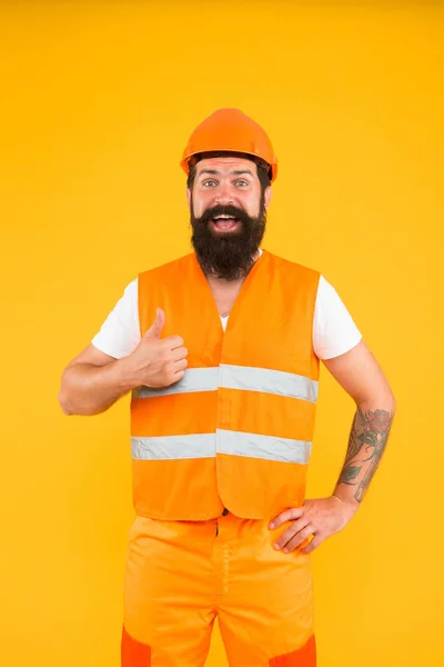 Good job. Engineering career concept. Architect builder engineer. Safety apparel for construction industry. Bearded brutal hipster safety engineer. Man engineer protective uniform orange background — Stock Photo, Image