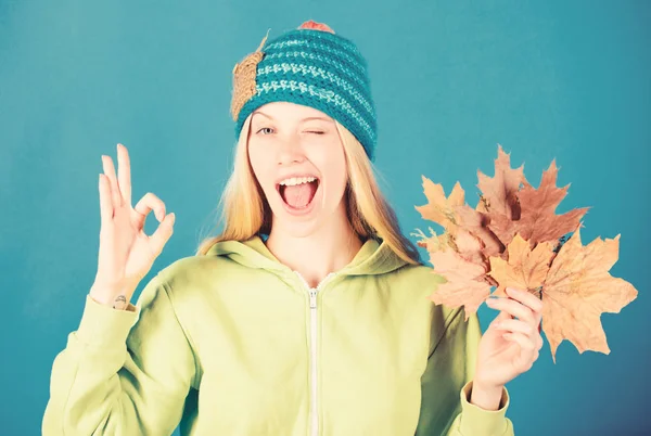 Active leisure and rest autumn season. Bright moment. Woman wear knitted hat hold fallen leaves. Skincare and beauty tips. Skincare routine for autumn. Enjoy autumn season. Autumn skincare tips