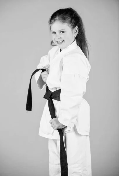 Small girl in martial arts uniform. little girl in gi sportswear. practicing Kung Fu. happy childhood. knockout. energy and activity for kids. sport success in single combat. Having a little break — Stock Photo, Image