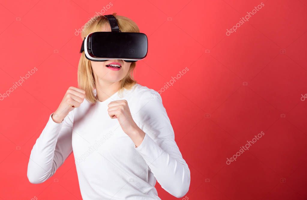 Excited smiling businesswoman wearing virtual reality glasses. Portrait of woman in blouse with virtual reality glasses on head isolated on red background. Woman with glasses of virtual reality.