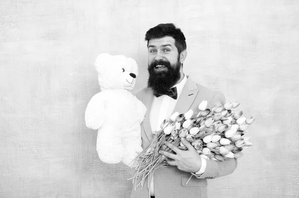 Memorize this moment. womens day. Formal mature businessman spring bouquet. 8 of march. bearded man in bow tie with tulip flowers. bride groom at wedding party. love date with flowers. Happy Birthday