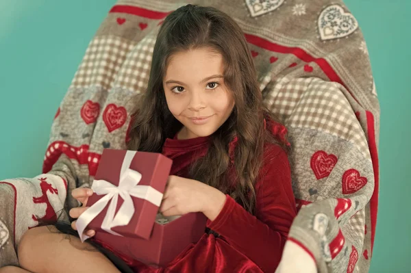 From Santa. Cute little child girl with new year present. Happy little smiling girl open new year gift box. Festive celebration of the New Year Eve at home. Merry Christmas and Happy New Year